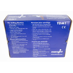 A blue cardboard box for a Marcfríst TDM Tile Drilling Machine, showing the product specifications and technical details in both English and French.