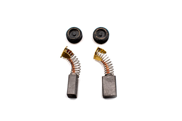 Two replacement electric motor carbon brushes with their black plastic caps and metal springs, arranged on a plain white background.