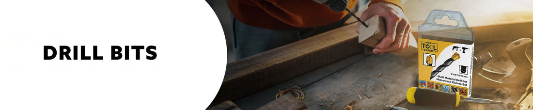 Person using masonary drill bit with a box of drill bits on a workbench.